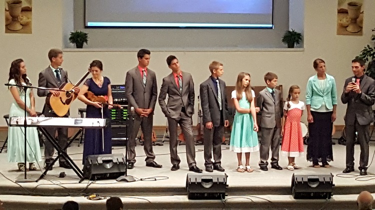 The Bontrager family, from left, Chelsy, Mitchell, Alison, Carson, Joshua, Denver, Elizabeth, Hudson, Rebecca, mother Rebecca and father Marlin, performed Thursday evening at the First Baptist Church in Perry.