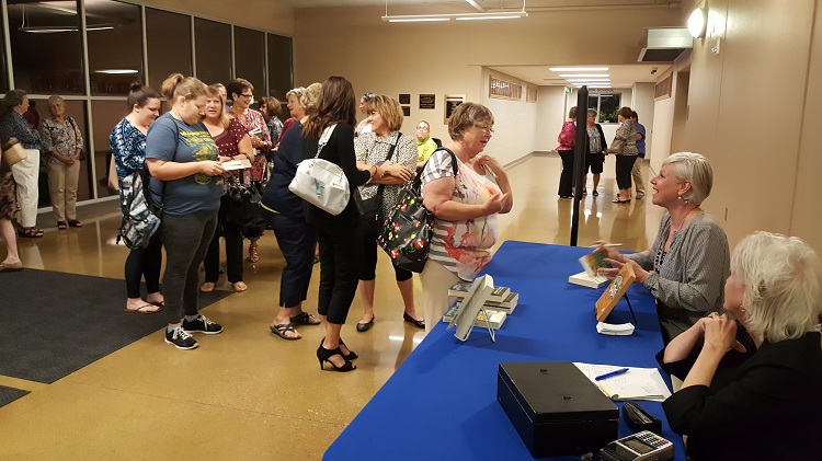 Local readers lined up to have their copies of "Missing Pieces" signed by the novel's author, Heather Gudenkauf, at the All Dallas County Reads One Book event Tuesday at the Perry Performing Arts Center.