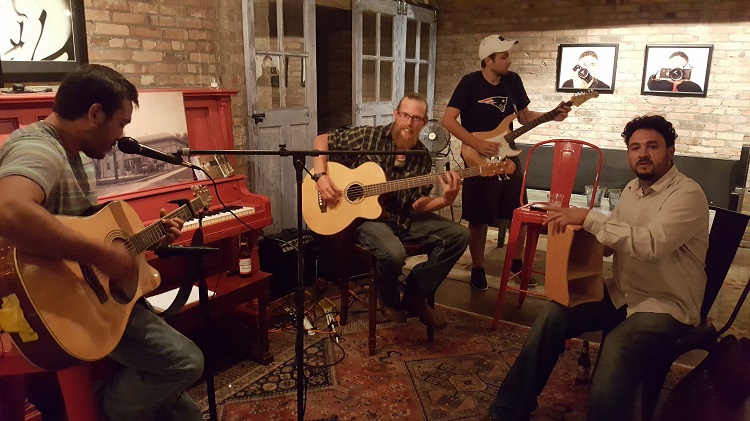 Andrew Gonzalez, left, sat in on a few numbers with the band in the Cellar of La Poste Thursday. The folk sounds lent a pleasant air to the small talk over beer, wine and tacos.