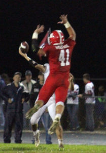 Perry quarterback Adan Medina is pressured by Ballard's Cade Wilson as he throws deep in the third quarter Friday.