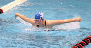 Sarah Vaughn lunges forward during the 100 butterfly at the Fort Dodge Invite Saturday. Photo courtesy Jim Dowd.