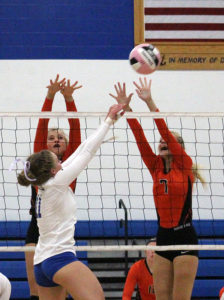 Grace Marburger hits the ball away from the defense for a point.
