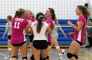 Grace Marburger (11), Isabel Saemisch, Syd Guerra (6), Jo Diw, Sid Vancil and Gabby West (right) celebrate Perry's 25-21 win in game three against Ballard Tuesday.