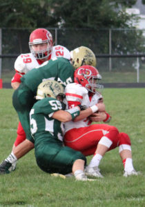 Boothe Carter is brought down by Devan Kirkman (55) as J.P. Nixon adds a little extra to the tackle.