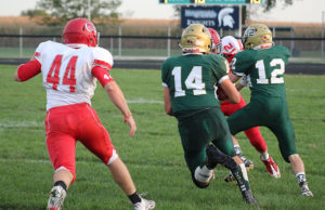 John Stucker (12) throws a downfield block as Brendan Bird runs for big yardage on the first play of the game.