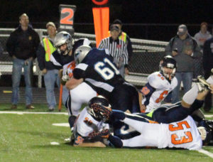 Dalton Bennett (61) and a teammate throw a NW Webster runner for a one-yard loss.