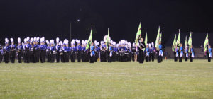 The Perry Blue Brigade and Color Guard prepare to march off the field after entertaining the crowd during halftime of the Sept. 30 Homecoming game. The  band will march one final time this season when they perform at Friday's game at Dewey Field.