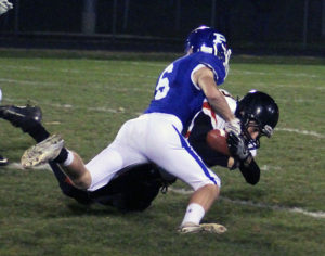 Perry's Brandon Kenyon strips Iowa Falls-Alden Logan Steelman on a kick return in the first quarter Friday at Dewey Field. Perry's Devon Archer would recover the fumble.