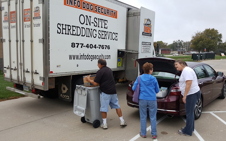 Mike Reeser, left, on Info Dog Security, and Mary Murphy, right, director of the Perry Public Library, served a steady stream of recyclers Saturday at the library's annual free shredding service.