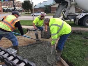 Big Bike enthusiasts, from left, Josh Weubker, Alan Kelleher and Mike Landals, poured the concrete pad and walkway last month. Many local sponsors have donated labor toward the connector-trail project.