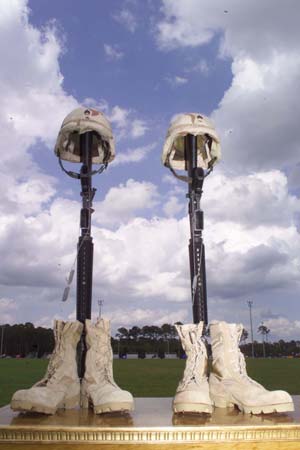 The iconic military image is known as the Fallen Soldier Battle Cross or the Battlefield Cross and sometimes simply Helmet Rifle Boots.