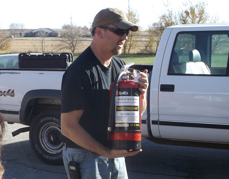 Perry Volunteer Fire Department First Assistant Chief Brian Eiteman instructs Perry Health Care Center staff on the proper use of a fire extinguisher during staff training Thursday.
