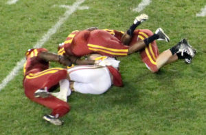 Seeley (top) finishes off his sack of Oklahoma quarterback Baker Mayfield as two teammates join the play. Mayfield is a Heisman Trophy finalist this year.