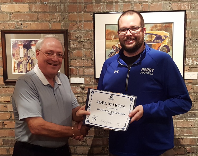 Past President of the Perry Optimist Club International Dr. Randy McCaulley, left, presented Joel Martin with a certificate of membership in Wednesday's induction ceremony.