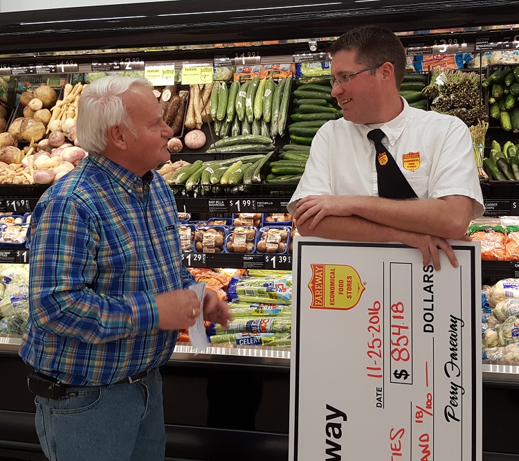 John Andorf, left, and Travis Landgrebe chat Friday morning about the good deeds done in Perry and for Perry.