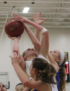 Mary Hansen is fouled while trying to score under the basket.